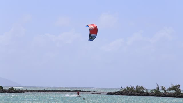 Man-kitesurfing-in-ocean,-extreme-summer-sport-in-island-Mauritius