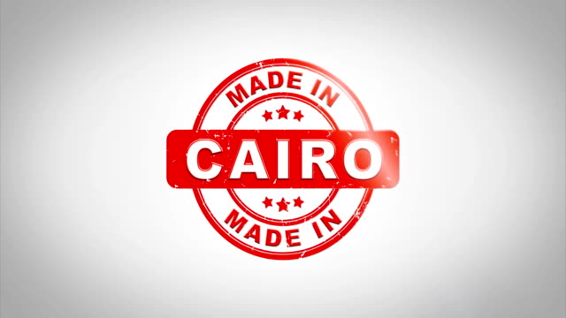 Made-In-CAIRO-Signed-Stamping-Text-Wooden-Stamp-Animation.-Red-Ink-on-Clean-White-Paper-Surface-Background-with-Green-matte-Background-Included.