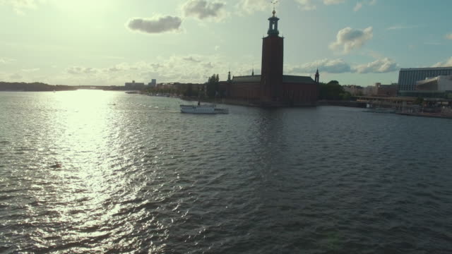 Drone-shot-of-Stockholm-City-Hall-and-ferry-boat
