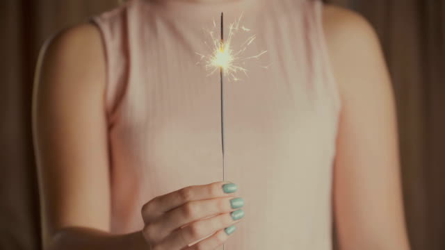 Footage-woman-holding-sparkler-and-celebrating-new-year-or-success-business