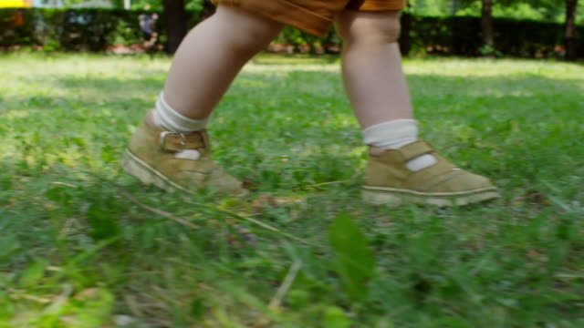 Unrecognizable-Baby-Taking-First-Steps-Outdoors