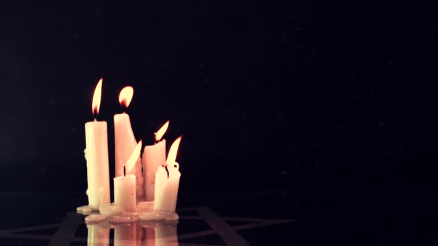 Six-burning-candles-and-the-Star-of-David,-rotation-360-degrees-against-a--background.