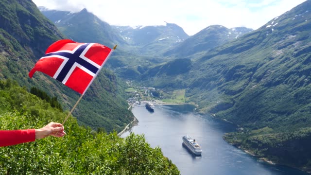 Norwegische-Flagge-und-Kreuzfahrtschiff-am-Fjord\",,,