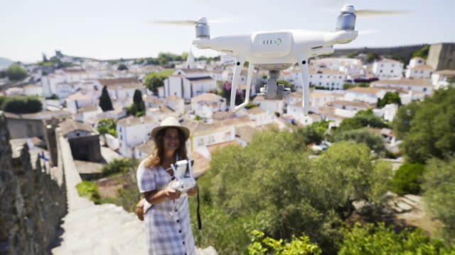 Woman-piloting-drone-in-old-town