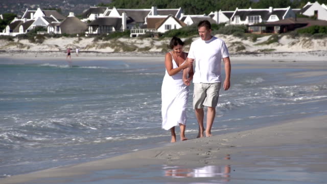 Romantic-couple-walking-along-beach,-Cape-Town,-South-Africa
