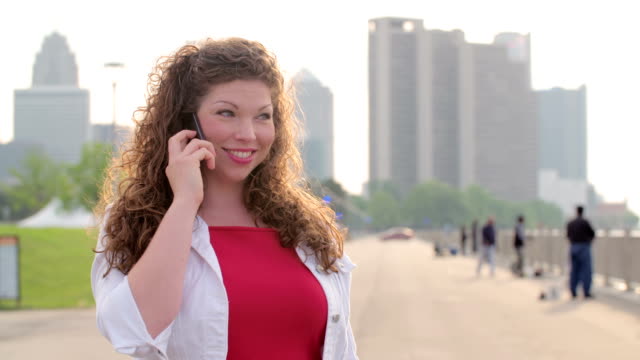 Slow-motion-woman-smiling-and-using-cellphone-in-Detroit