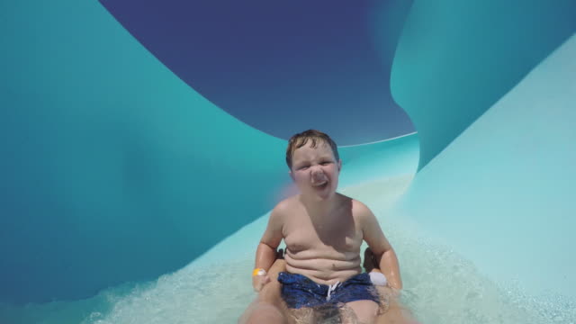 Happy-young-boy-going-down-waterslide-Cape-Town