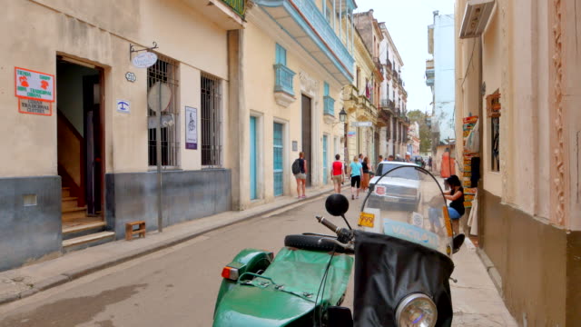 4-K-la-Habana,-Cuba-Sidestreet-Alley-en-Cuba,-bicicleta-y-turistas