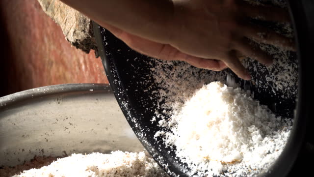 Woman-extraction-of-coconut-pulp