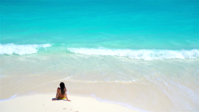 Young-woman-on-the-beach-in-water-view-above