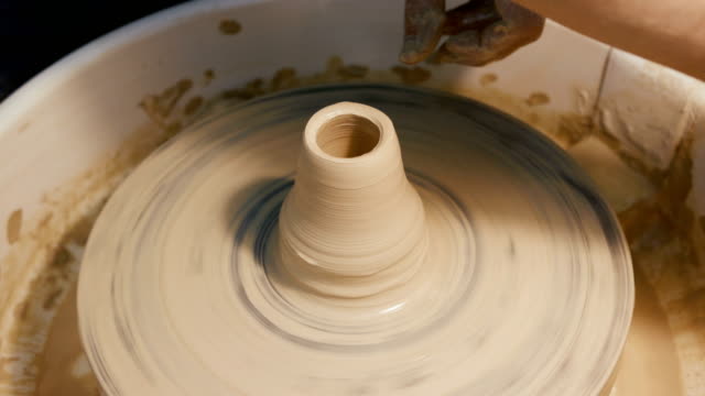 Man's-hands-making-clay-ware-on-the-potter's-wheel