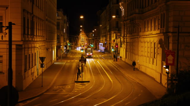 Timelapse-tram-stop-Silingrovo-city-square-in-Brno-passing-through-public-transport-during-the-night-long-street