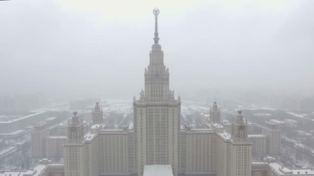 Aerial-footage-of-Moscow-State-University-in-winter-cloudy-and-snowy-weather