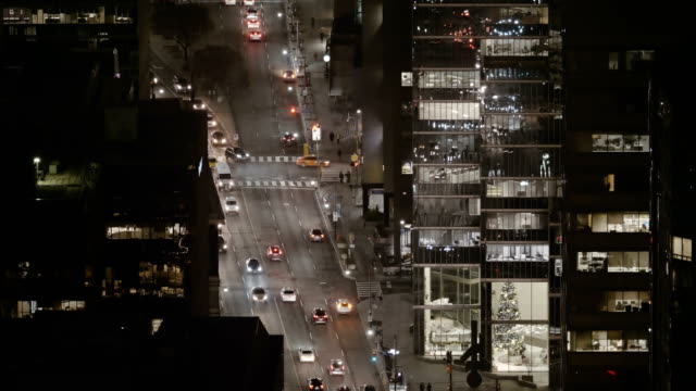 Establishing-shot-of-sparse-traffic-in-a-modern-city-late-at-night.
