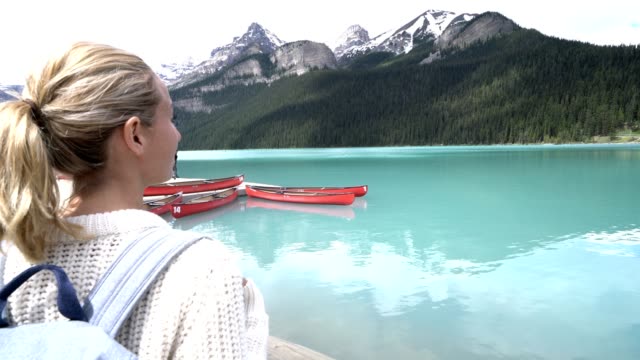 Young-woman-contemplating-nature-at-Lake-Louise