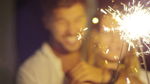 Laughing-Couple-Kissing-when-Holding-Sparkler