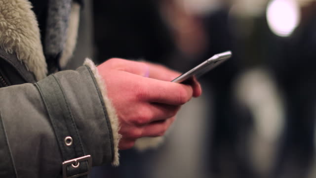 Close-up-of-hands-holding-cellphone-device-checking-emails
