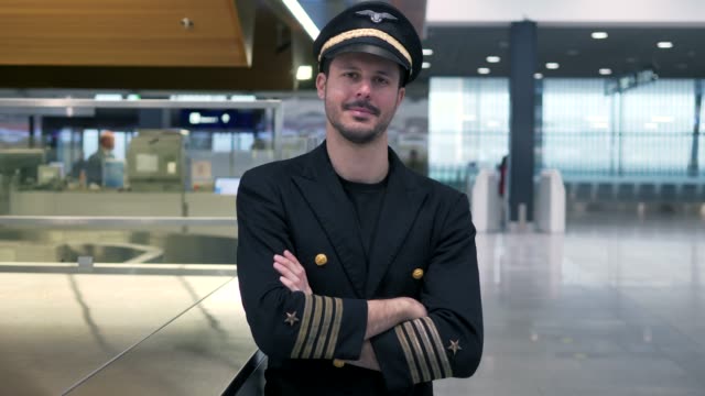 Young-airplane-captain-standing-on-airport