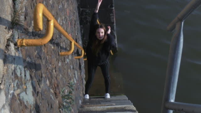 Young-Woman-Dancing-on-River-Steps