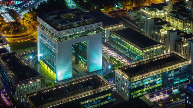 night-illumination-dubai-financial-block-roof-top-panorama-4k-tim-elapse-united-arab-emirates