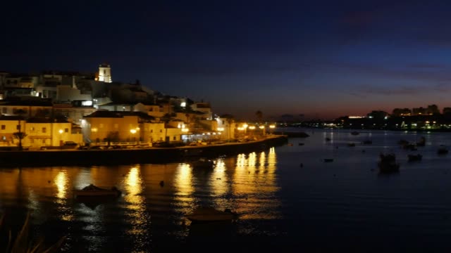 Night-panorama-over-a-boat-in-Ferragudo,-Portugal
