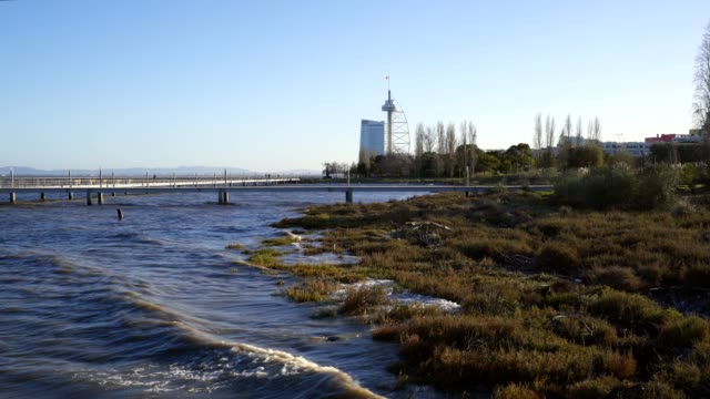 Torre-Vasco-da-Gama-Tower-view-from-the-pier-with-waves-from-the-Rio-Tejo-Tagus-river