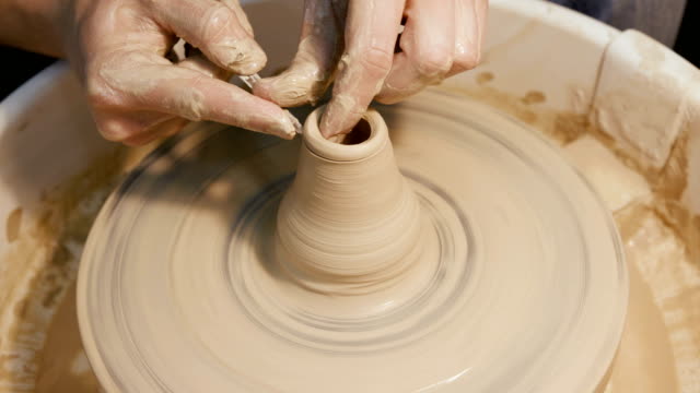 Man's-hands-making-clay-ware-on-the-potter's-wheel