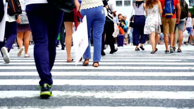 Legs-of-people-walking-on-the-crosswalk-in-Shibuya,-Tokyo-in-Japan.-4K