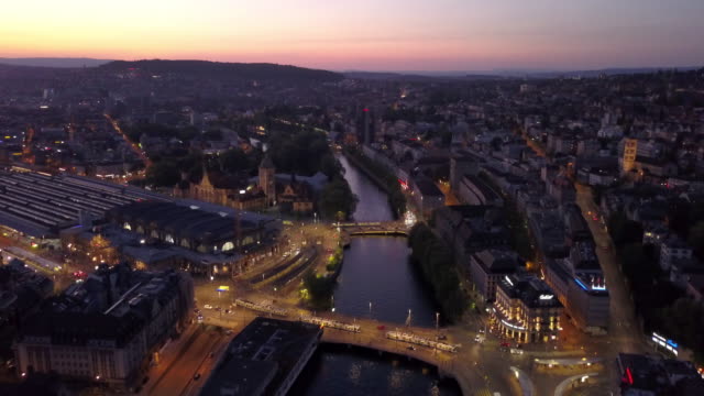 sunset-illuminated-zurich-city-center-riverside-aerial-panorama-4k-switzerland