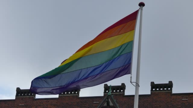 Rainbow-flag-in-the-city-center.-Rainbow-flag-(LGBT-movement)-fluttering-in-the-wind.-Close-up.