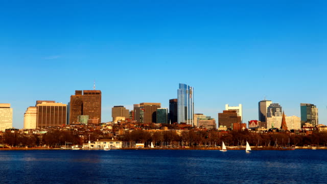 Timelapse-Boston-city-center-with-sailboats-in-foreground