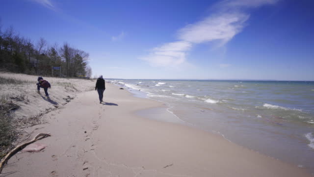 mother-and-boy-kid-walking-on-beach-ontario-countryside-nature-sunny-sun-summer