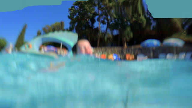 Underwater-footage-of-kids-jumping-and-diving-in-a-swimming-pool