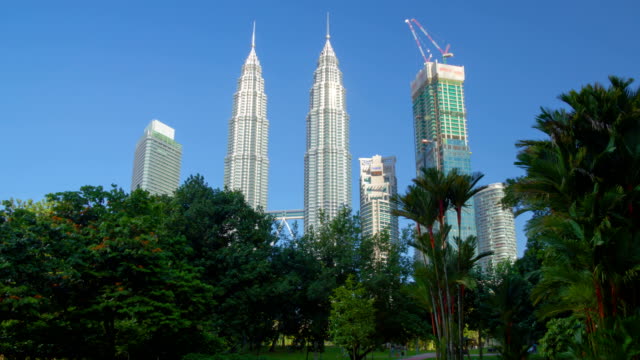 Petronas-Towers-in-Kuala-Lumpur-,-view-from-park.-Motion-Timelapse