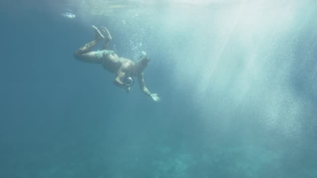 Underwater-Footage-of-Man-Diving-in-the-Sea-Exploring-Coral-Reefs-and-Sea-Life.-Swimming-with-Fishes.