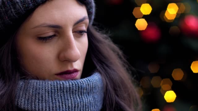 close-up-portrait-of-pensive-cute-brunette-thinking-and-smiling-at-camera--Christmas-Time--oudoor