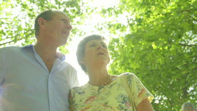 Active-senior-caucasian-tourist-couple-backlit-by-the-sun