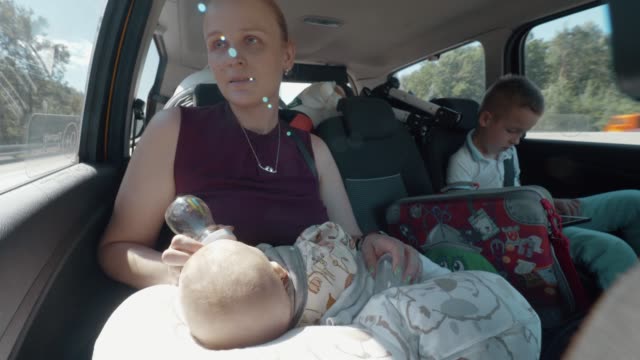 Family-car-journey.-Mum-traveling-with-children