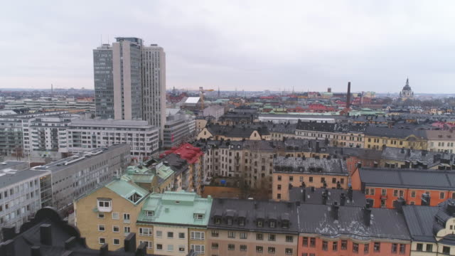 Aerial-view-of-Stockholm-city-buildings-in-Södermalm-district.-Drone-shot-flying-over-rooftops,-skyscraper-building-in-the-background