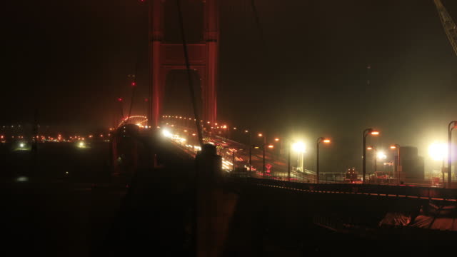 Misty-traffic-bridge-at-night