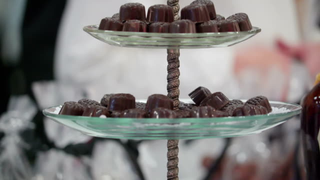The-three-tiered-container-with-lots-of-chocolates-on-it