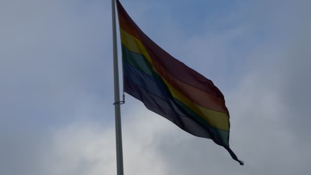 Rainbow-flag-in-the-city-center.-Rainbow-flag-(LGBT-movement)-fluttering-in-the-wind.-Close-up.