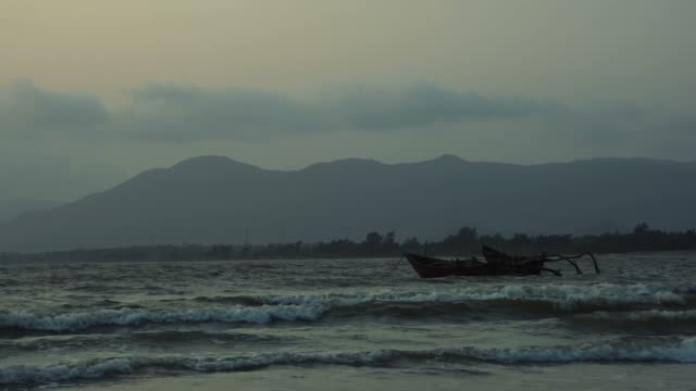 Empty-boats-floating-on-sea-waves-in-late-rain-evening.