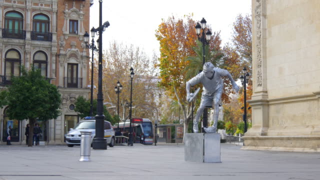 seville-day-light-street-silver-living-statue-4k-spain