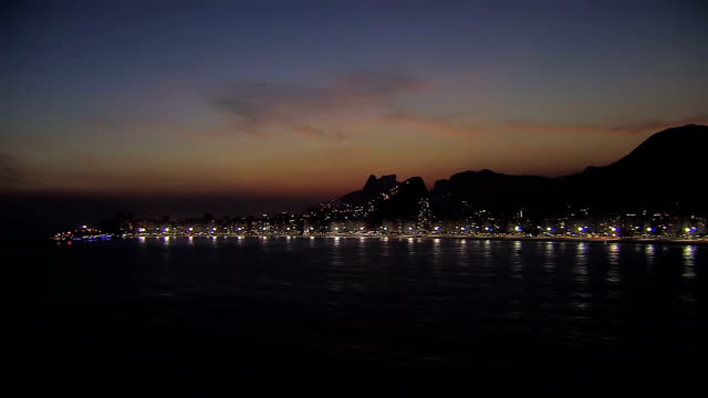 Low-angle-aerial-view-of-Rio-de-Janeiro-at-night,-Brazil