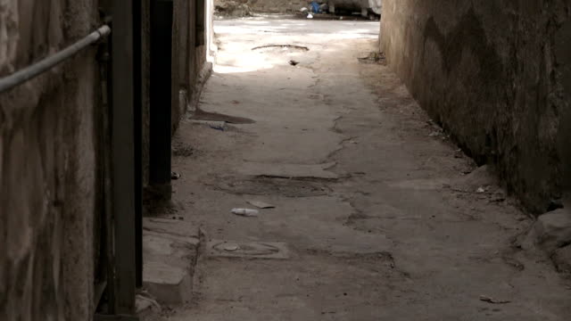 Arab-woman-walking-down-the-street-at-the-end-of-an-alley