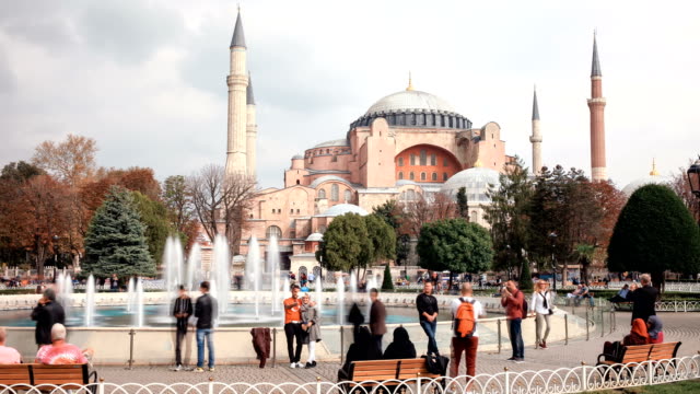 Tourists-walking-in-Sultanahmet-Square-Hagia-Sophia,-a-former-Orthodox-patriarchal-basilica,-later-a-mosque-and-now-a-museum-in-Istanbul,-Turkey