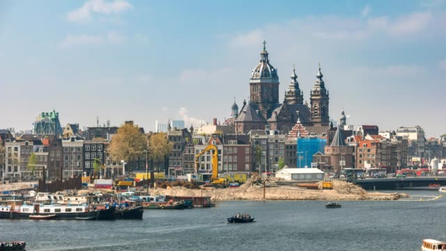 Amsterdam-city-skyline-timelapse-with-Basilica-of-Saint-Nicholas,-Amsterdam,-Netherlands,-4K-Time-Lapse