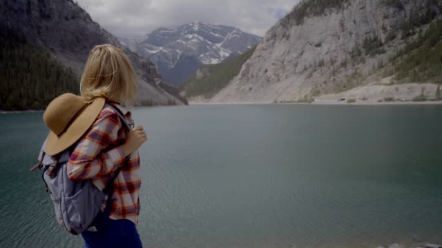 oung-woman-hiker-looking-at-mountain-lake