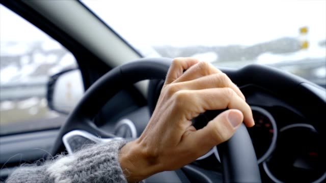 Close-up-on-hand-and-wheel,-woman-in-car-driving,-road-trip-concept-vacations